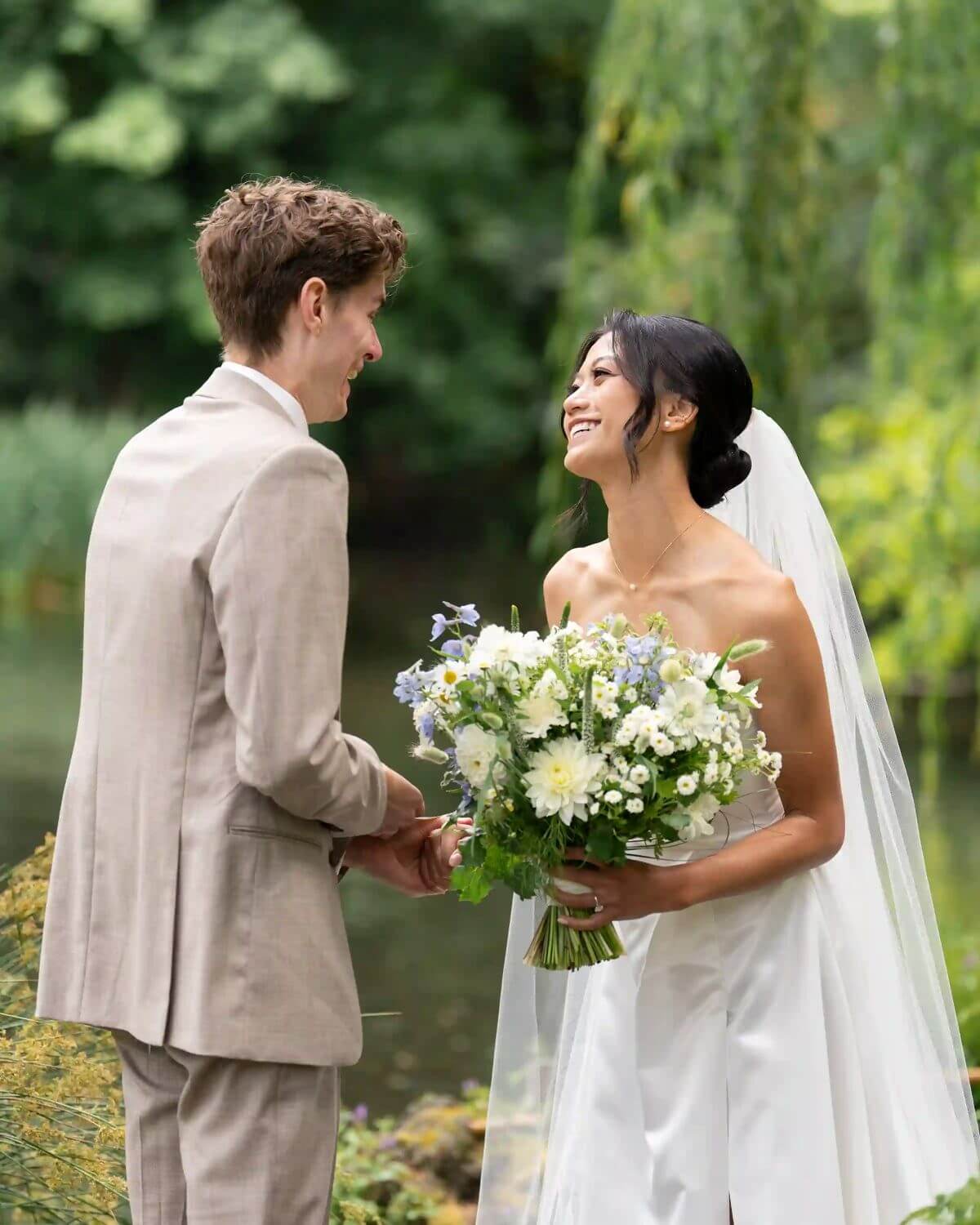 Bride and groom exchanging vows with Kvetka Flower bouquet in hand, lush garden backdrop in Portland, OR