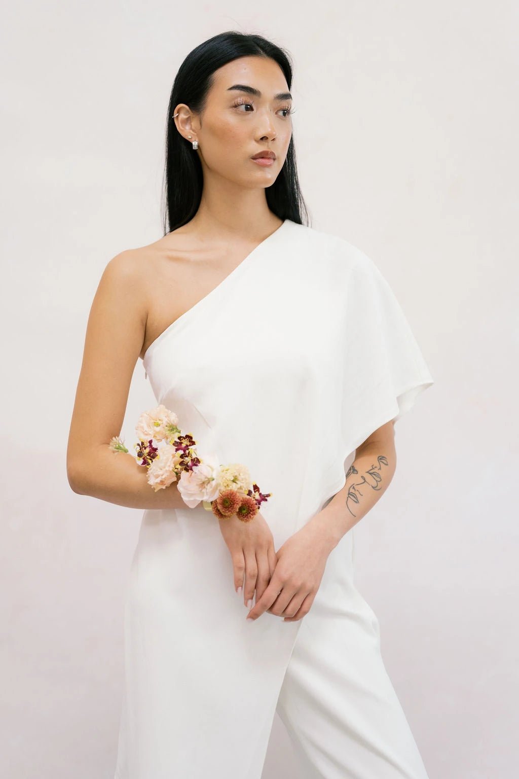 Modern wearable wrist corsage on bride with blush and burgundy flowers by Portland florist Kvetka Flower