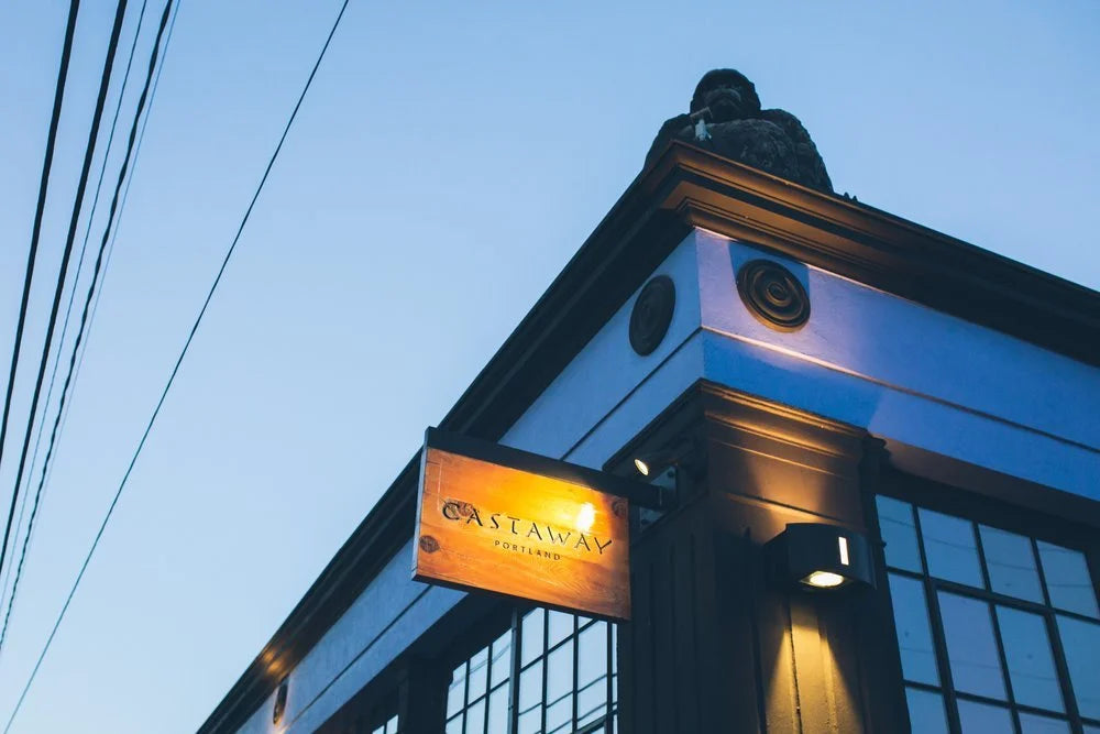Building exterior with a lit sign against a clear sky