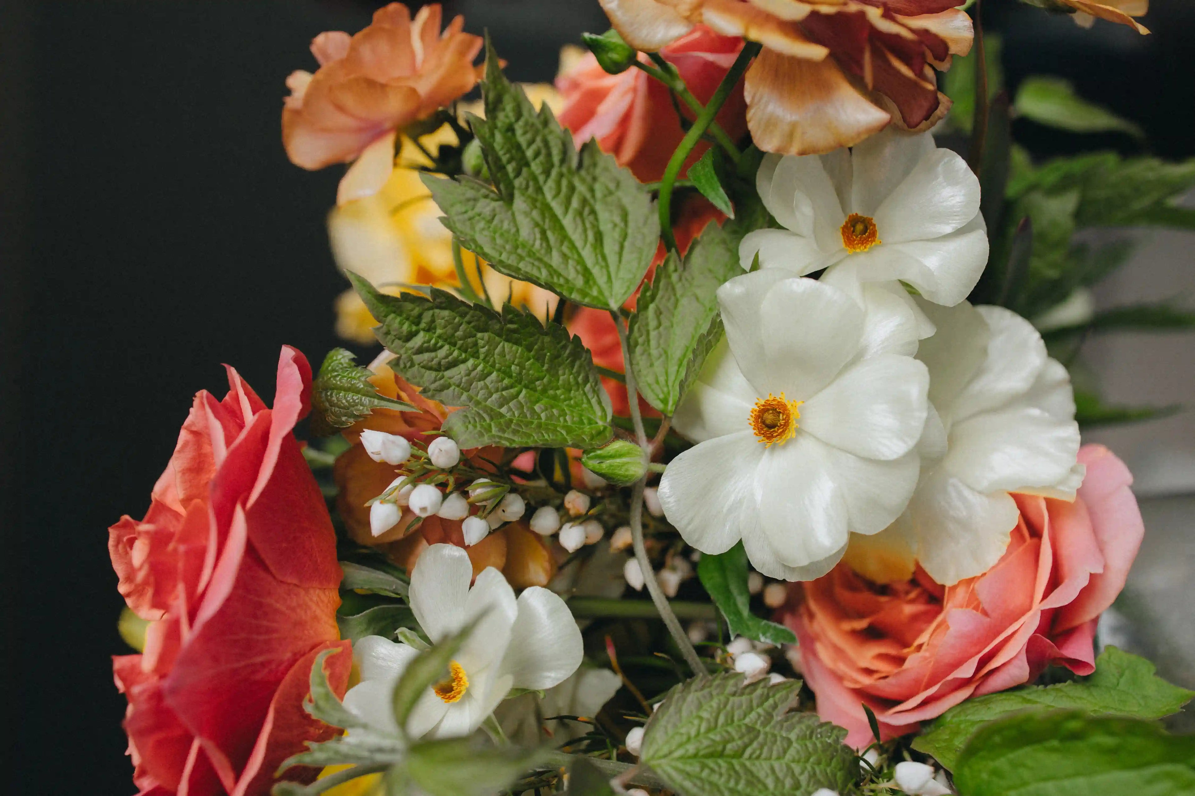 Lush European-style flower bouquet for Portland delivery, featuring vibrant orange roses, fresh raspberries, and delicate white Butterfly ranunculus from Kvetka Flower.