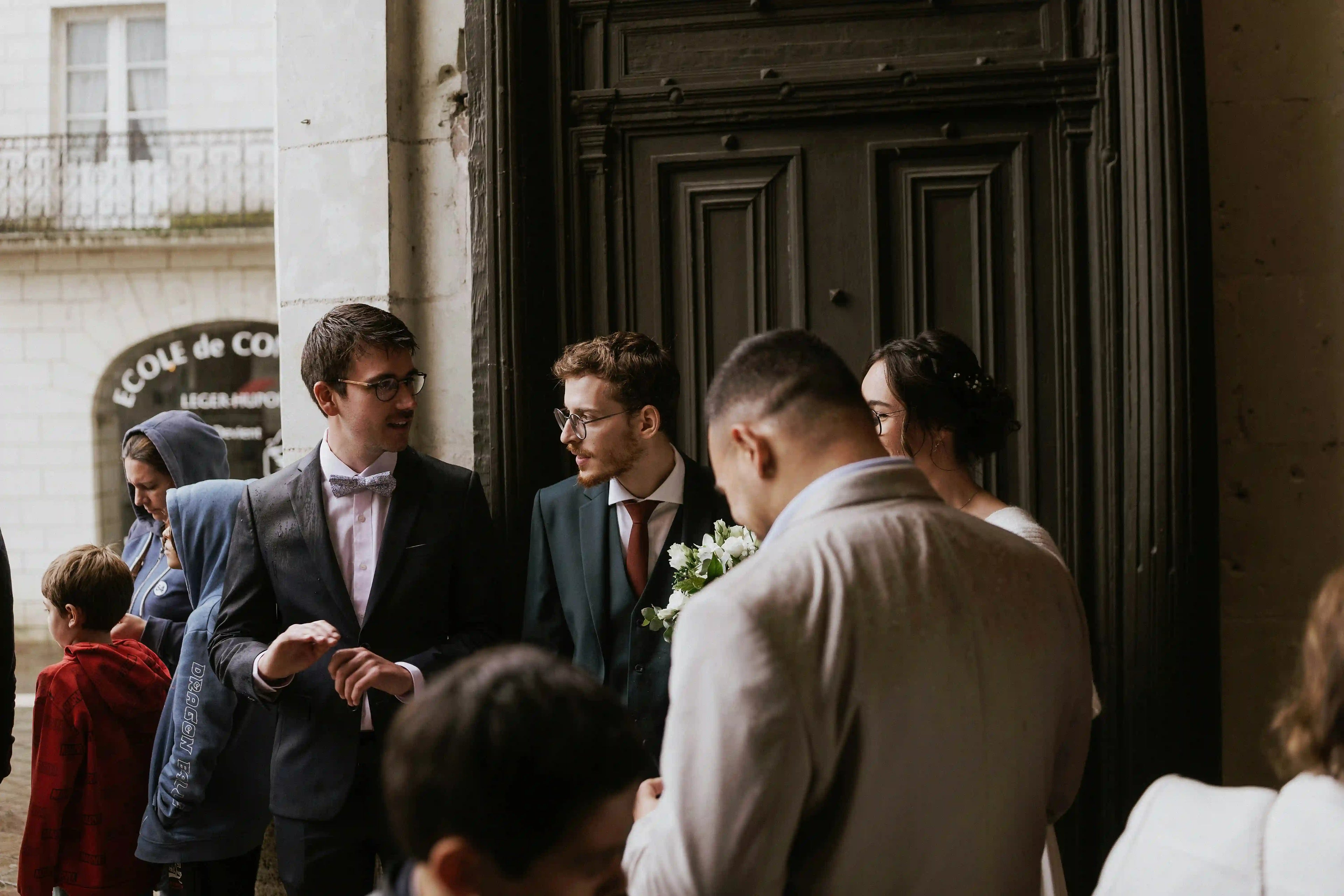 Wedding coordinator greeting guests at venue entrance