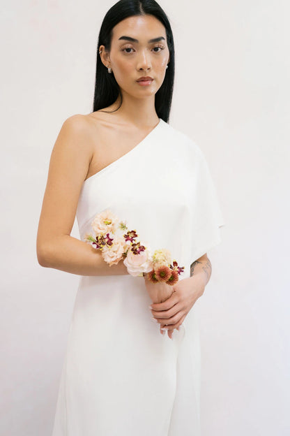 Bride wearing statement forearm corsage with terracotta chrysanthemums and blush lisianthus Kvetka Flower