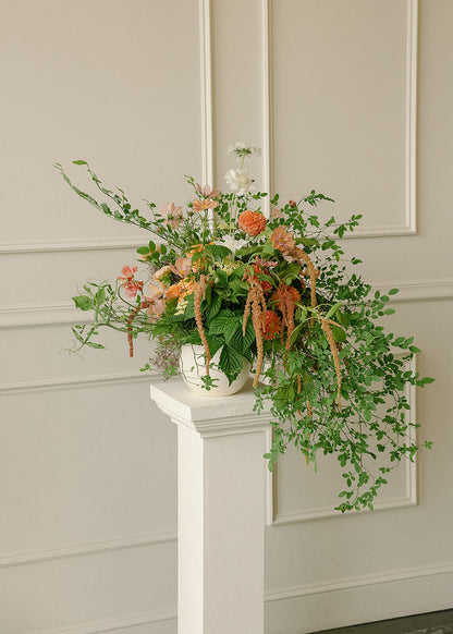 Minimal indoor ceremony setup at Tendue with floral columns by Kvetka Flower