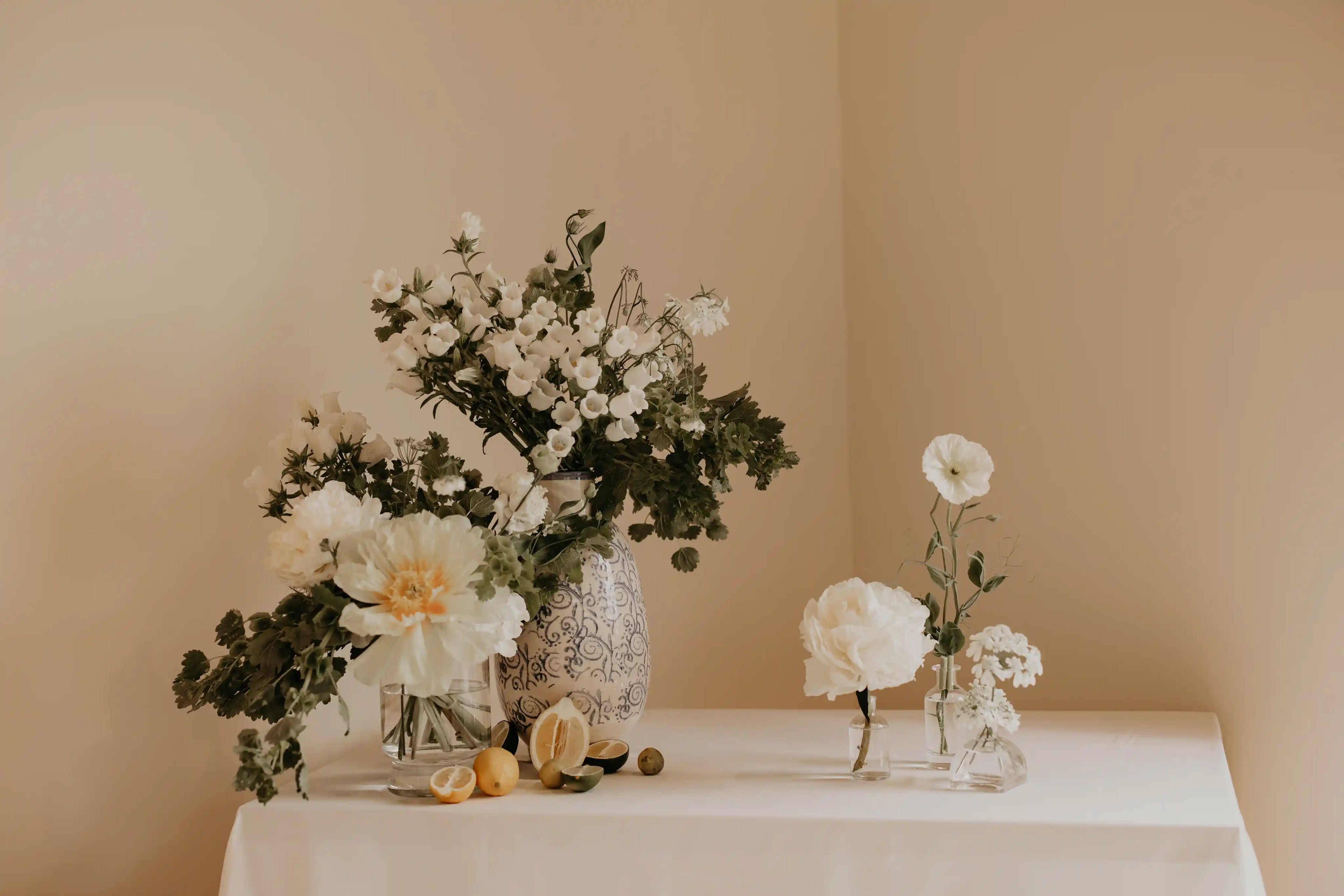 White floral arrangements with local peonies and lemons — welcome table styling for a wedding near Portland, in Vancouver WA, by Kvetka Flower.