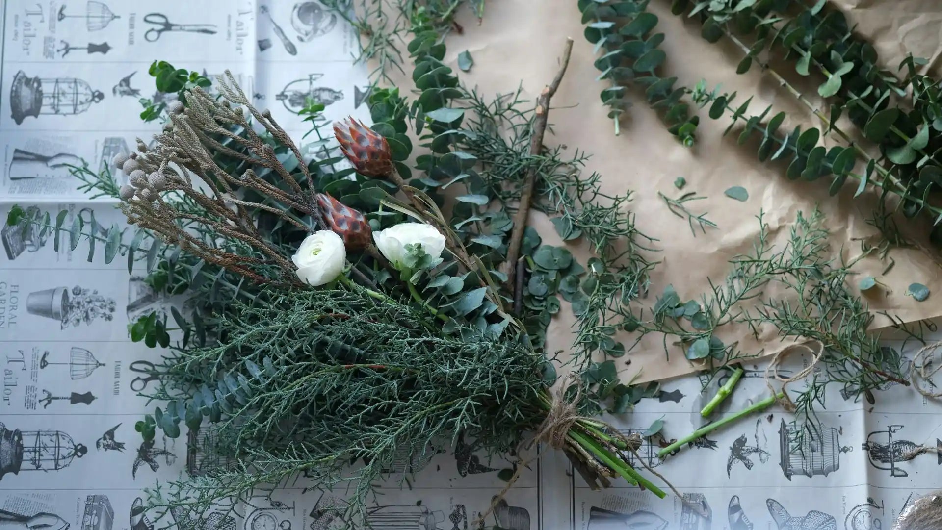 Greenery and flowers on a textured surface with a vintage-style pattern