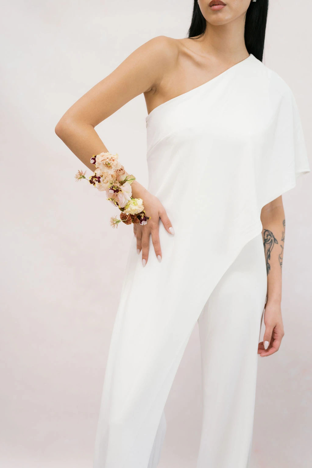 Bride wearing sculptural wrist corsage with blush lisianthus and burgundy orchids by Kvetka Flower Portland